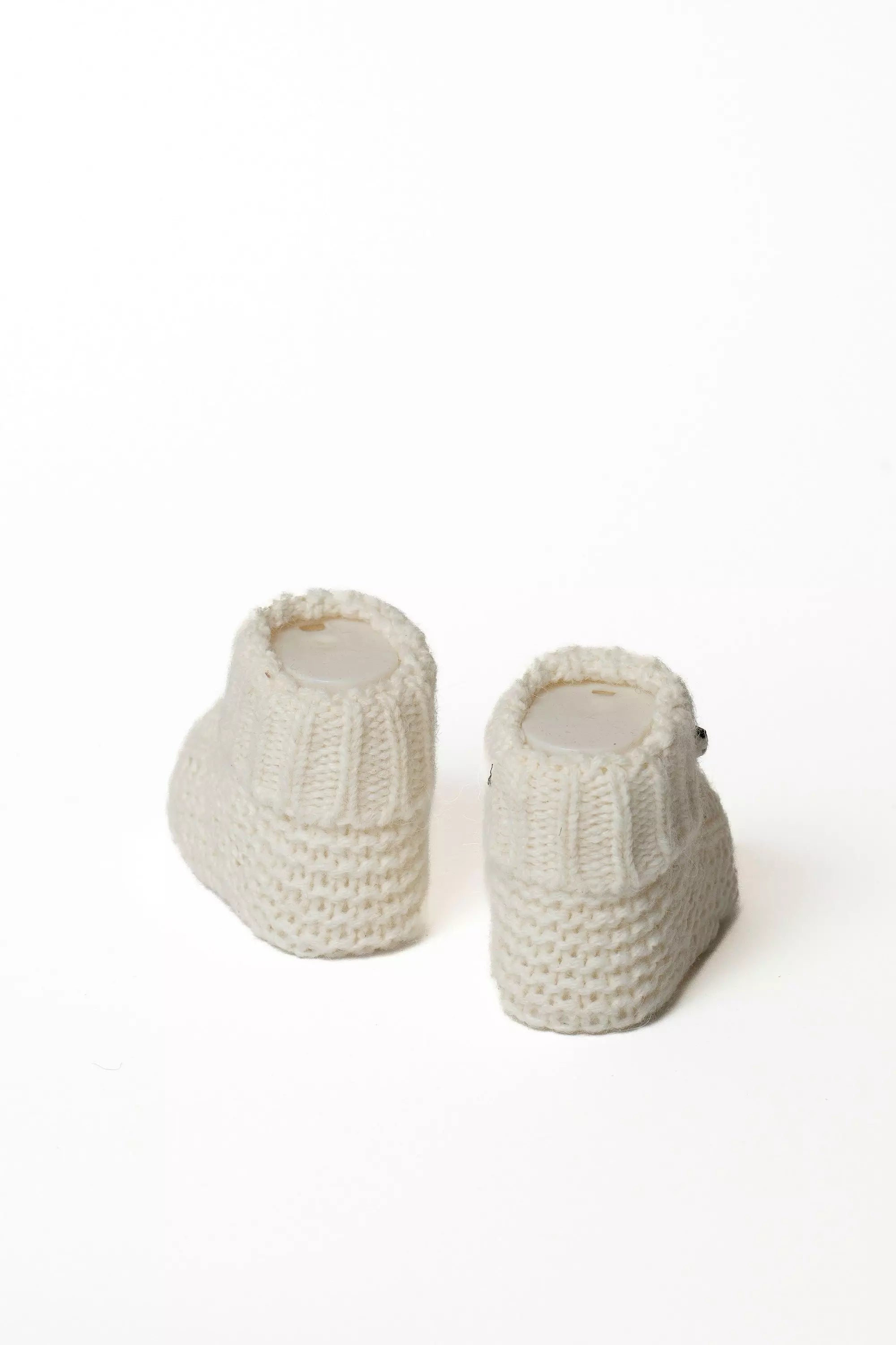 Paar weisse Baby Strickschuhe, Ansicht von hinten, Hochwertige Baby Strickmode