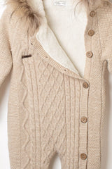 Baby-Winteroverall in Beige, geöffnet, mit kuscheligem, weißem Futter, Zopfstrickmuster und abnehmbarem Fellbesatz an der Kapuze